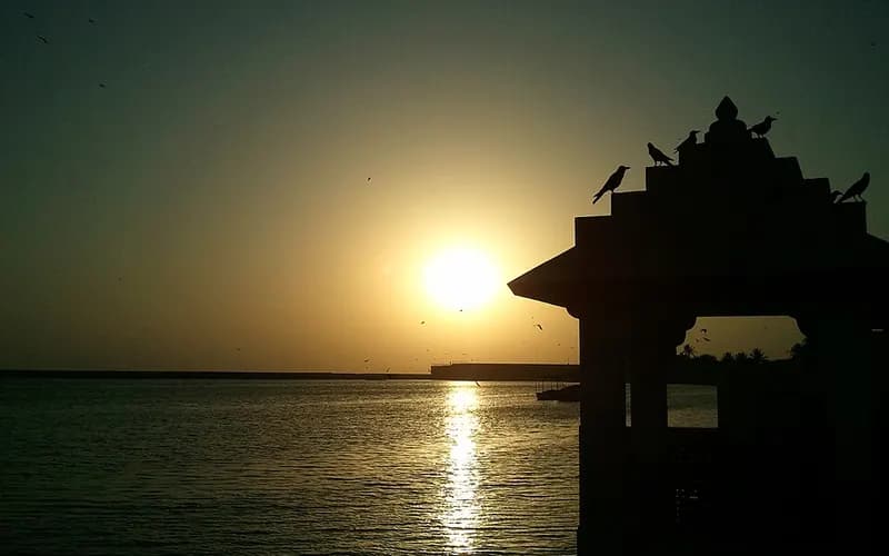 Sunset over the water at Triveni Ghat, Somnath